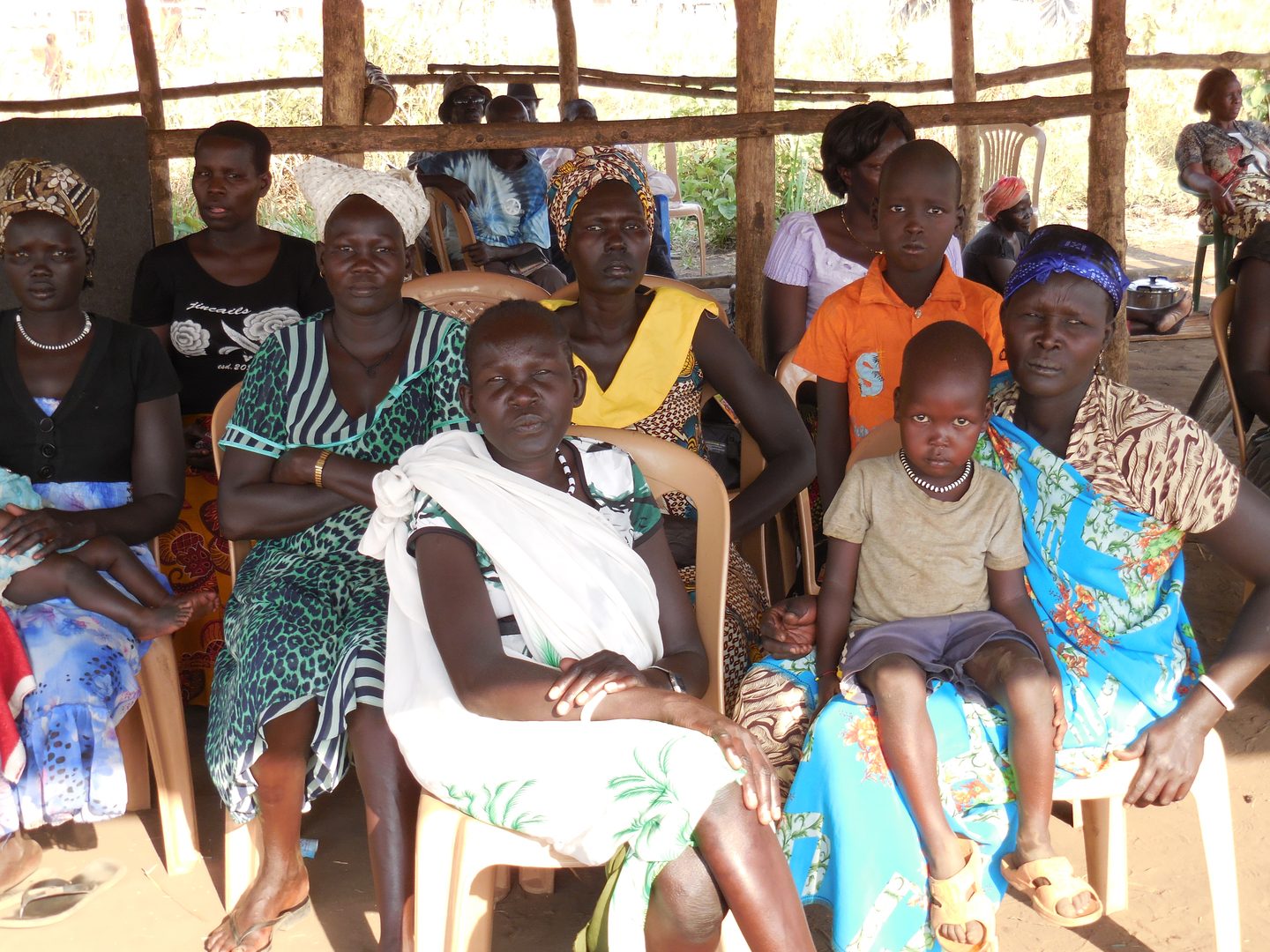 Women and children seated at a conference