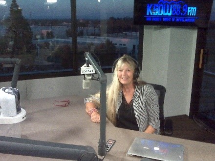 Denise at the microphone in a radio studio